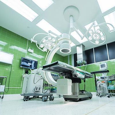 A operation theatre with latest medical equipment in brightly lit room.