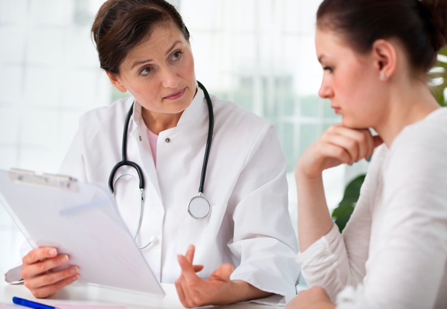 A female GP asking health questions during a patients pre-conception health check-up